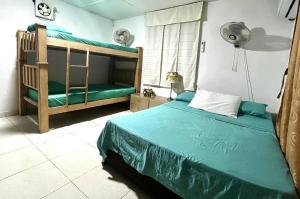 a bedroom with a bed and a bunk bed at Casa campestre Magyli in Puerto Salgar +23 photos