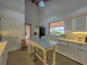 a kitchen with a table in the middle of it at Villas Valle in Valle de Bravo +13 photos