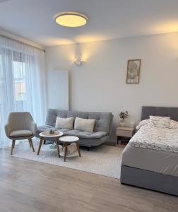 a living room with a bed and a couch at Rezidence Sadová Zlín in Zlín