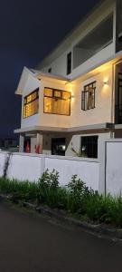 a large white house at night with lights at Crater Serenity Studio in Curepipe