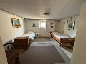 a small room with two beds and a desk at Chez Zabou in Carpentras