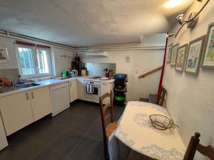 a kitchen with white cabinets and a table and a table and a table at Chez Zabou in Carpentras