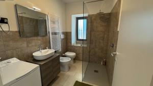 a bathroom with a sink and a toilet and a shower at La Cà - Casa Vacanze in Torre De' Roveri +15 photos