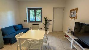 a living room with a blue couch and a table at La Cà - Casa Vacanze in Torre De' Roveri