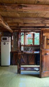 a kitchen with a stove and a refrigerator in a cabin at Cabaña Mirador del Valle in Lago Puelo
