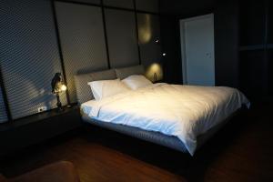 a bedroom with a large bed with white sheets and pillows at Flat 6 - Luxury Designer Apartment in Odăile