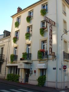 a hotel with plants on the balconies of a building at Hotel California in Vichy