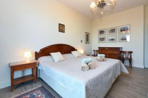 a bedroom with a bed with two stuffed animals on it at Villa Mirador in Padenghe sul Garda +72 photos