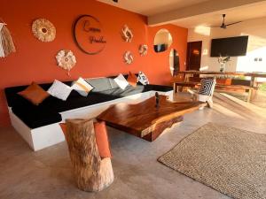 a living room with a couch and a wooden table at Luxury Ocean View Villa in Brisas de Zicatela