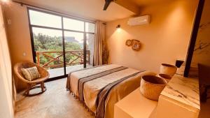 a bedroom with a bed and a large window at Luxury Ocean View Villa in Brisas de Zicatela +42 photos