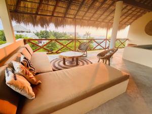 a living room with a couch and a table at Luxury Ocean View Villa in Brisas de Zicatela