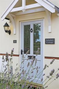 a white door of a house with a sign on it at 2 Bed in Southwold oc-scl in Reydon