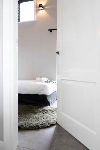 a bedroom with a door leading to a bed at Landleven Luttenberg in Luttenberg