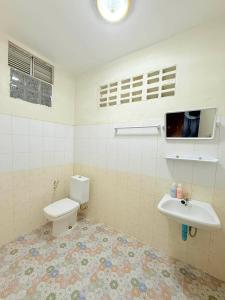 a bathroom with a toilet and a sink at The Warm House in Ban Komo Sip Paet +14 photos