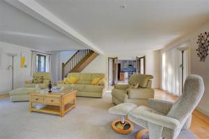 a living room with couches and chairs and a table at 3 Bed in Thursford oc-2370 in Thursford