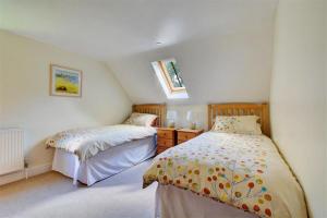 a bedroom with two beds and two windows at 3 Bed in Thursford oc-2370 in Thursford