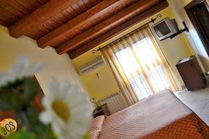 a bedroom with a bed and a window with a television at Al Galileo Siciliano in Palermo