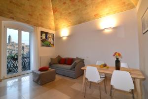 a living room with a table and a couch at L'Affaccio Dell'Abate in Matera