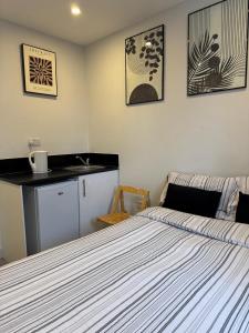 a bedroom with a bed and a sink in it at Brigstock 4 in Thornton Heath