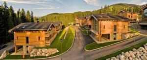 arial view of a home with a road with houses at Chalets Jasná Centrum APT KROWKA - Free Jacuzzi & Sauna and Chopok view in Belá