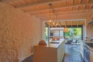 a kitchen with an island with a counter top at Villa des Amandes in Bédarieux