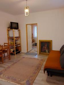a living room with a couch and a table at Happy Place Apartment in Lupeni
