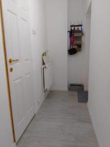 a hallway with a white door and a floor at Happy Place Apartment in Lupeni +7 photos