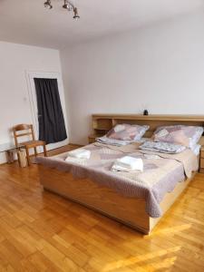 a large bed in a room with a wooden floor at Privatzimmer 3 in Klingenbach +10 photos