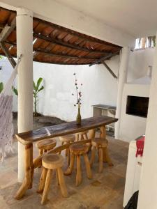a wooden table and stools in a room at Casa De Vó in Amontada