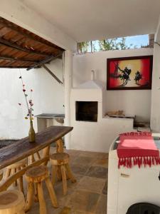 a living room with a table and a bench at Casa De Vó in Amontada