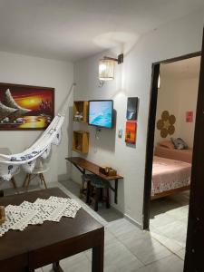 a room with a bedroom with a desk and a bed at Casa De Vó in Amontada