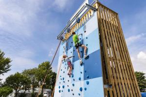 two people climbing on a climbing wall at Weymouth Bay Holiday Static Caravan in Preston +9 photos