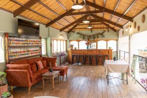 a living room with a couch and a bar at Tariq Sacred Valley in Urubamba