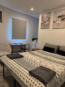 a bedroom with a bed with two towels on it at Brigstock3 in Thornton Heath