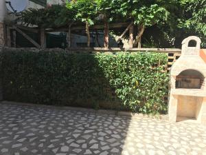 a brick wall with a pizza oven in front of it at Nesa Beach Front Apartment in Poreč