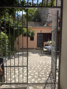 an open gate to a patio with a table at Nesa Beach Front Apartment in Poreč