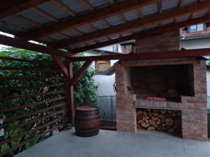 a patio with a brick fireplace and a barrel at OLD TOWN ROAD in Karlovac