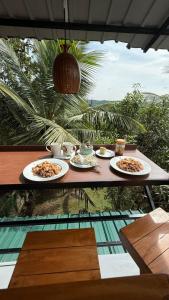 a table with three plates of food on it at PEACEFUL GREEN VILLA in Unawatuna