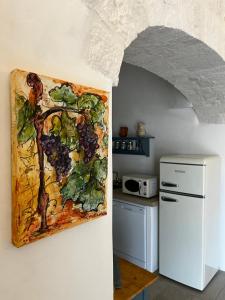 a painting of grapes on the wall of a kitchen at Trullo in vigna in Cisternino