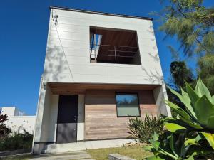 a white house with a window at Villa YUKUI in Onna