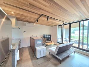 a living room with a couch and a table at Villa YUKUI in Onna