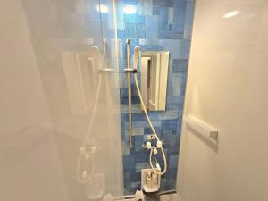 a bathroom with a shower with a toilet in it at Villa YUKUI in Onna +21 photos