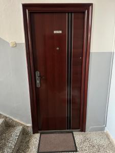 a wooden elevator door in a building at Apartman Jojo in Čapljina
