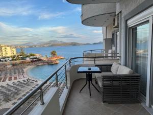 a balcony with a view of a body of water at Zero Zero Apartments Sarande in Sarandë