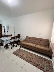a living room with a couch and a table at Refúgio do Churrasco in Matinhos