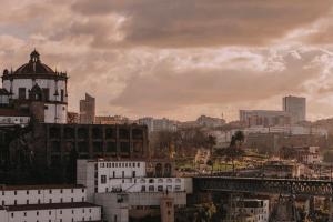 a view of a city with buildings and a bridge at LENSCAPE Coterie in Porto