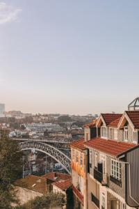 a view of a city with a bridge and buildings at LENSCAPE Coterie in Porto