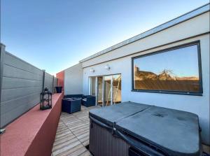 a large window on the side of a building at Loft Moderne Avec Jacuzzi Roft top Le B in Baccarat