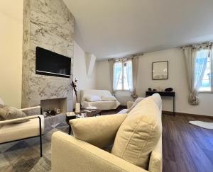 a living room with a couch and a fireplace at ROUERGAT's LITTLE GITE in Villefranche-de-Rouergue +5 photos