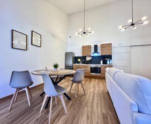 a living room with a table and chairs and a couch at ROUERGAT's LITTLE GITE in Villefranche-de-Rouergue